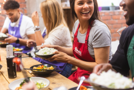 Class attendees enjoying the food they made round a table at Supper Club.