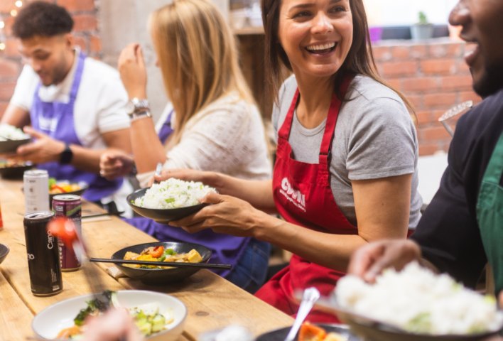 Class attendees enjoying the food they made round a table at Supper Club.